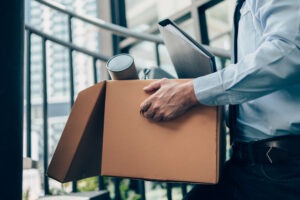 Fired man walking through office. An employment lawyer in Eden prairie can help you fight back and seek compensation for employment discrimination.