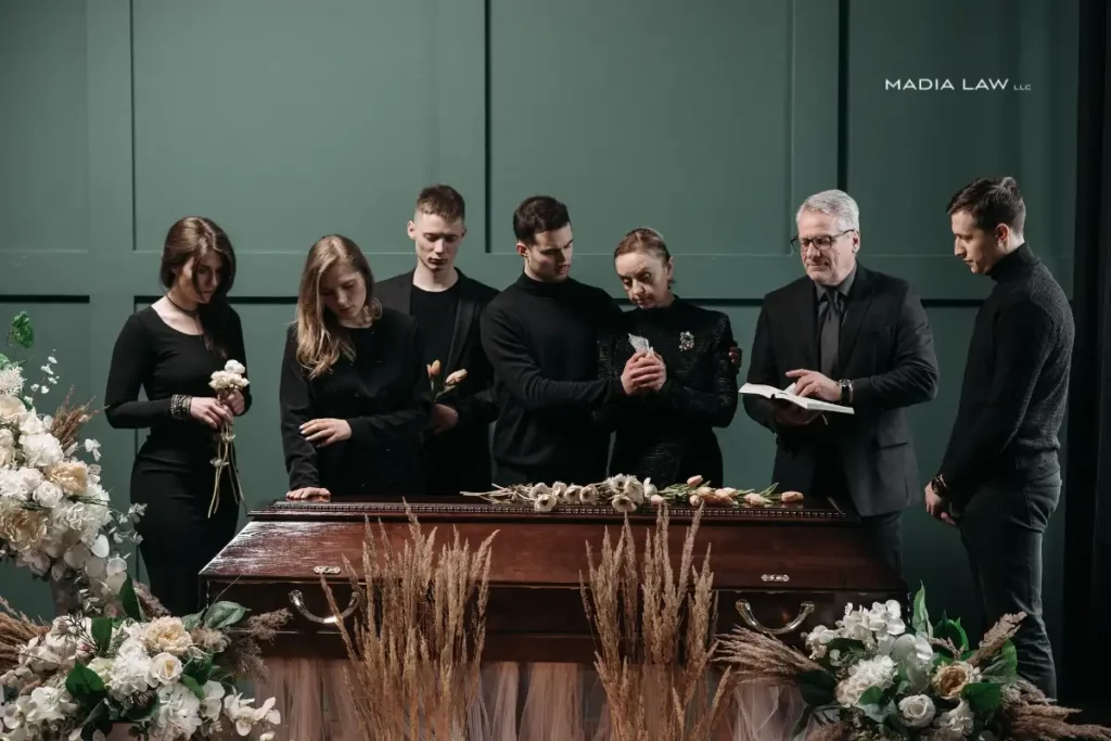Family gathered around a casket during a wrongful death funeral service
